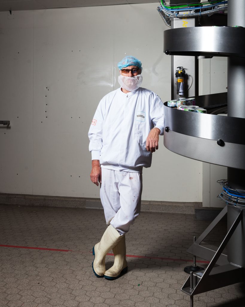 Hellendoorn, Gelderland, The NetherlandsAn ice cream maker – line operator stands in his work clothes next to the conveyor belt where the freshly made ice creams are carried to the freezer in the Ben & Jerry’s ice cream factory.  (Photo by: Guillaume Groen fotografie )